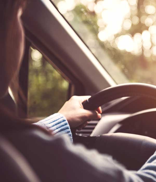 Woman Driving Car on a sunny day